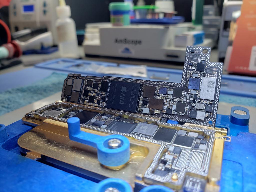 Placa lógica iPhone 12 Pro con chip A14 en jig de reparación